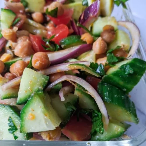 close-up of chickpea salad in a glass dish.