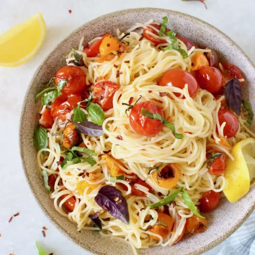 overhead of cherry tomato basil pasta in a bowl.