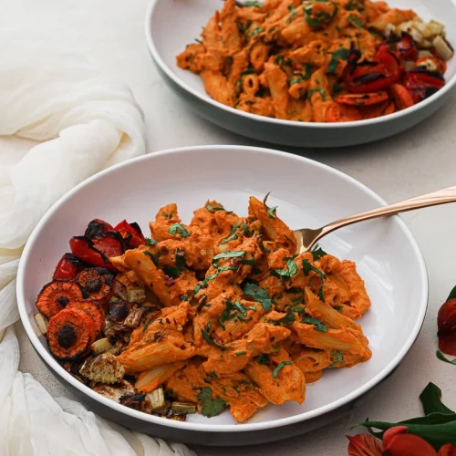 Indian style pasta in a dish with a fork in it.