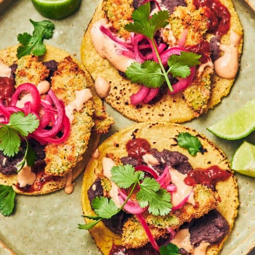 overhead of three air fried avocado tacos on a plate.