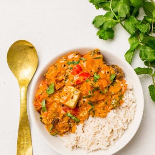 overhead of vegan tikka masala with rice in a white bowl.