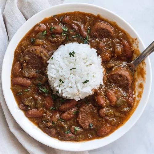 overhead of red beans and rice in a white bowl.