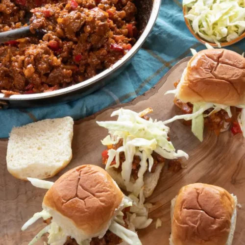 overhead of vegan sloppy Joe sliders on a wooden board.