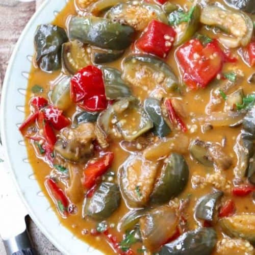 overhead of Thai eggplant curry in a bowl with right side cut off.