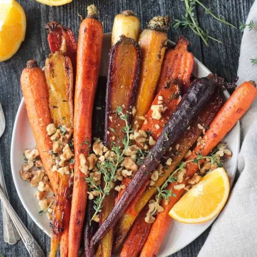 overhead of roasted rainbow carots with garnish.