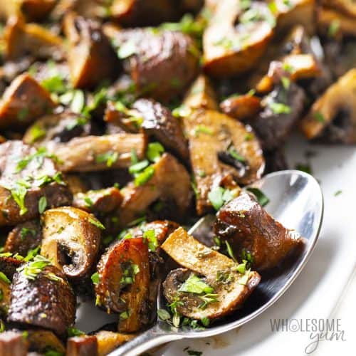 mushrooms on a serving dish with a spoon.