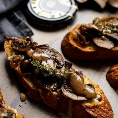 Mushroom Crostini on a cutting surface.