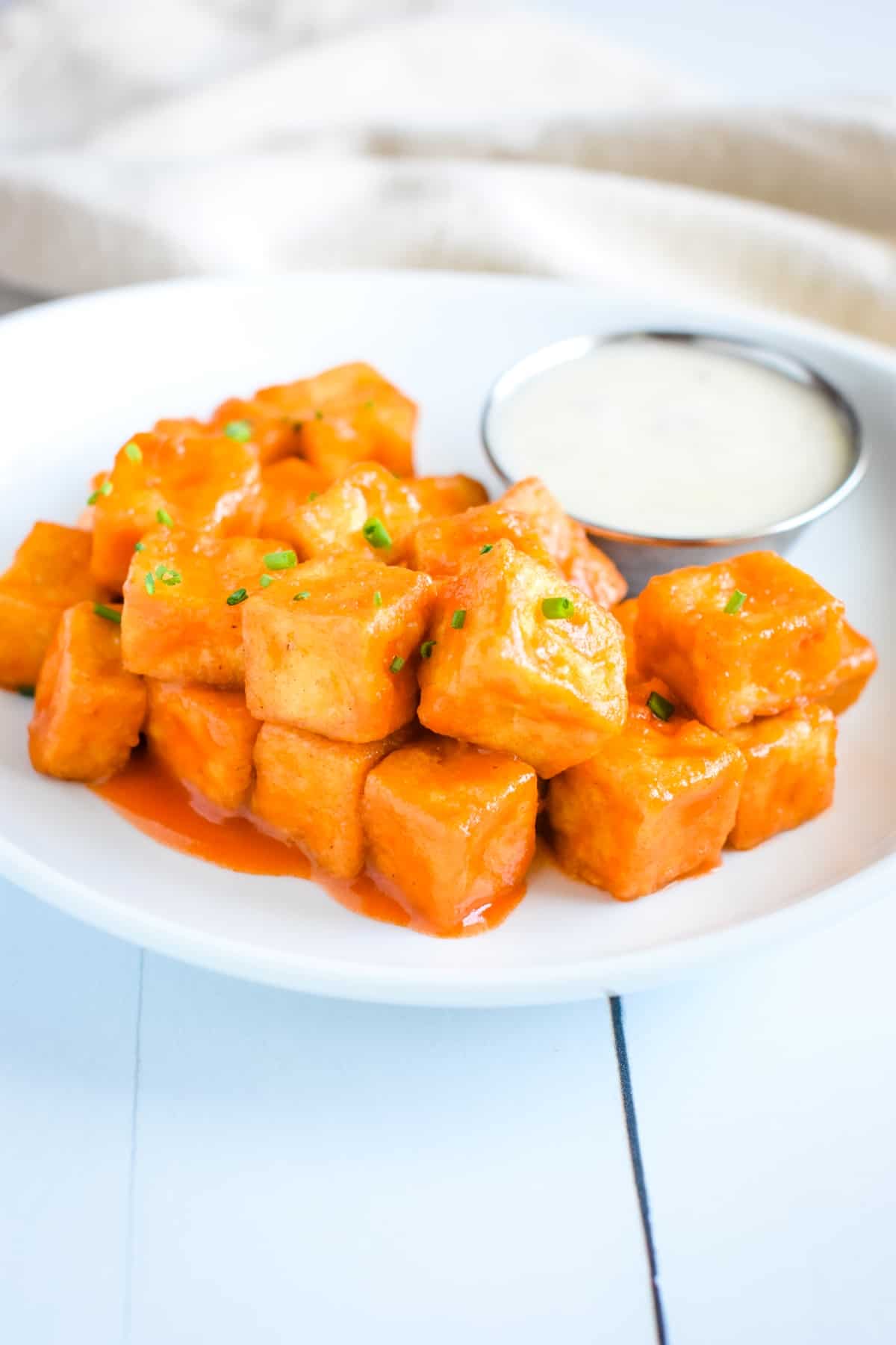 Air Fryer Tofu with Buffalo sauce on a plate.