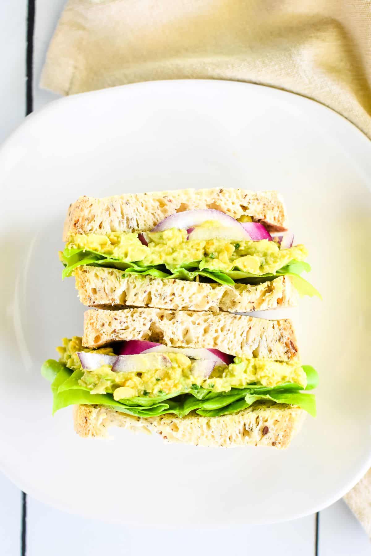 Sandwich sliced in half laying on a plate.