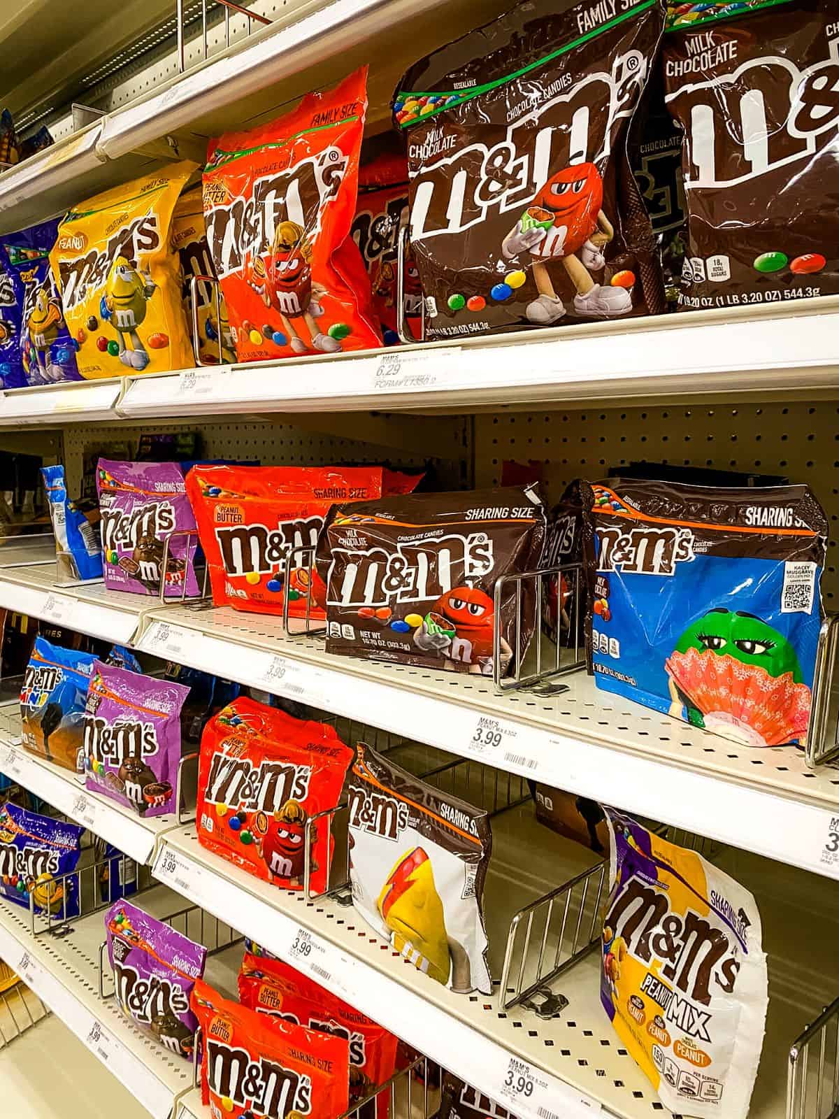 Bags of M&M's on supermarket shelves.