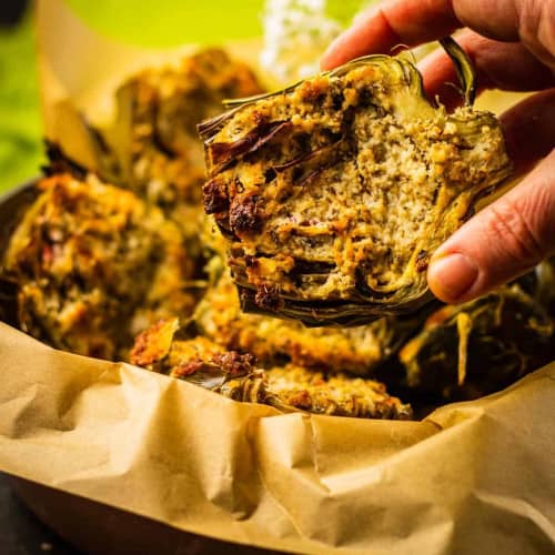 Roasted artichokes with parmesan in a dish.