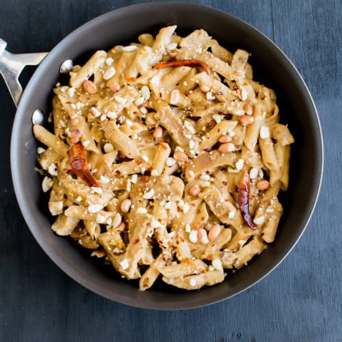 seitan and pasta in spicy peanut sauce in frying pan.