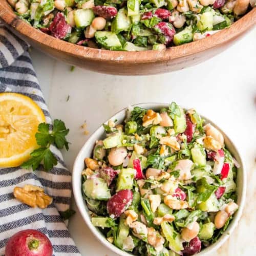 Kidney Bean Salad in a small dish next to a large wooden bowl.