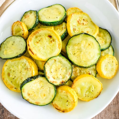 overhead view of cooked squash on a white plate.