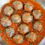 Impossible Burger Meatballs covered in sauce in a pan.