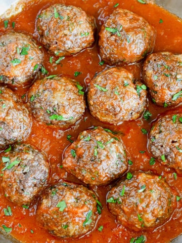 Impossible Burger Meatballs covered in sauce in a pan.