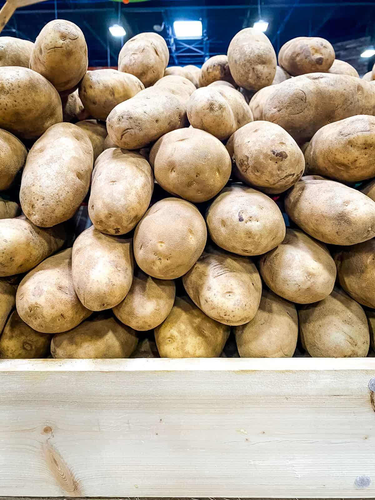 Stacks of russet potatoes at supermarket.