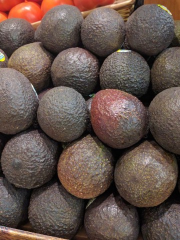 ripe avocados on store shelf.