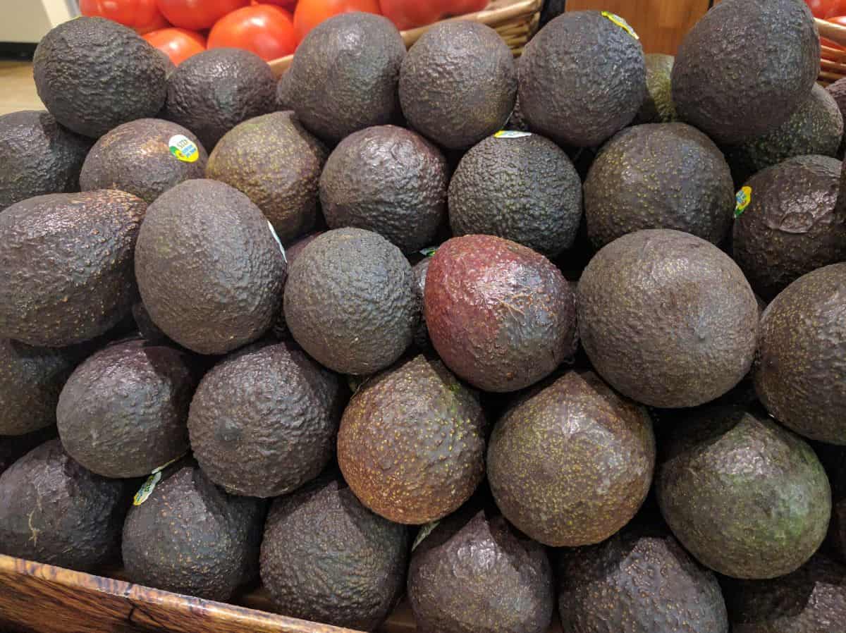 ripe avocados on store shelf.