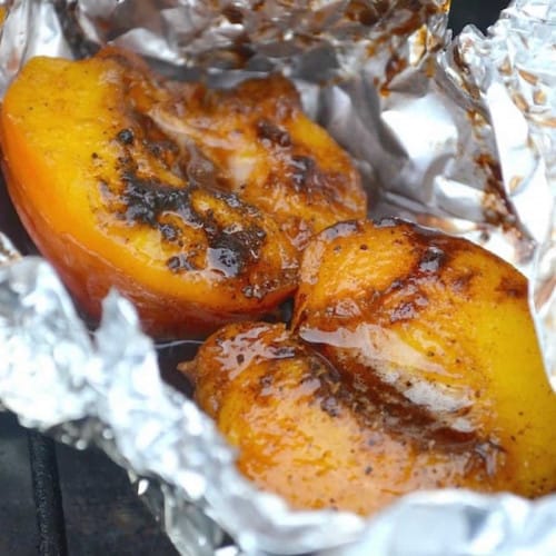 Grilled nectarines in aluminum foil.