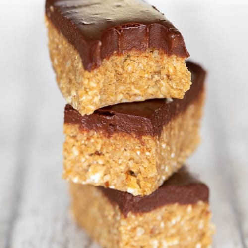 No bake bars stacked on a wood surface.