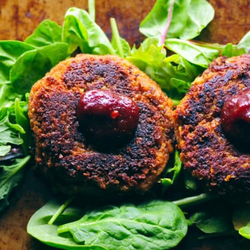 Vegan Chickpea Walnut Burgers on greens.