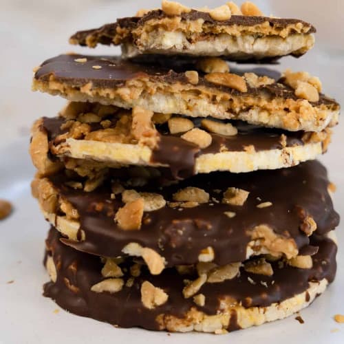 Chocolate peanut butter rice cakes stacked on a plate.