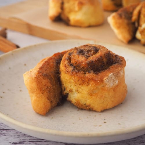 Air fryer cinnamon rolls on a plate.