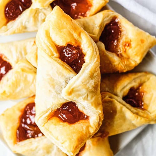 Puff pastry stacked on a plate.