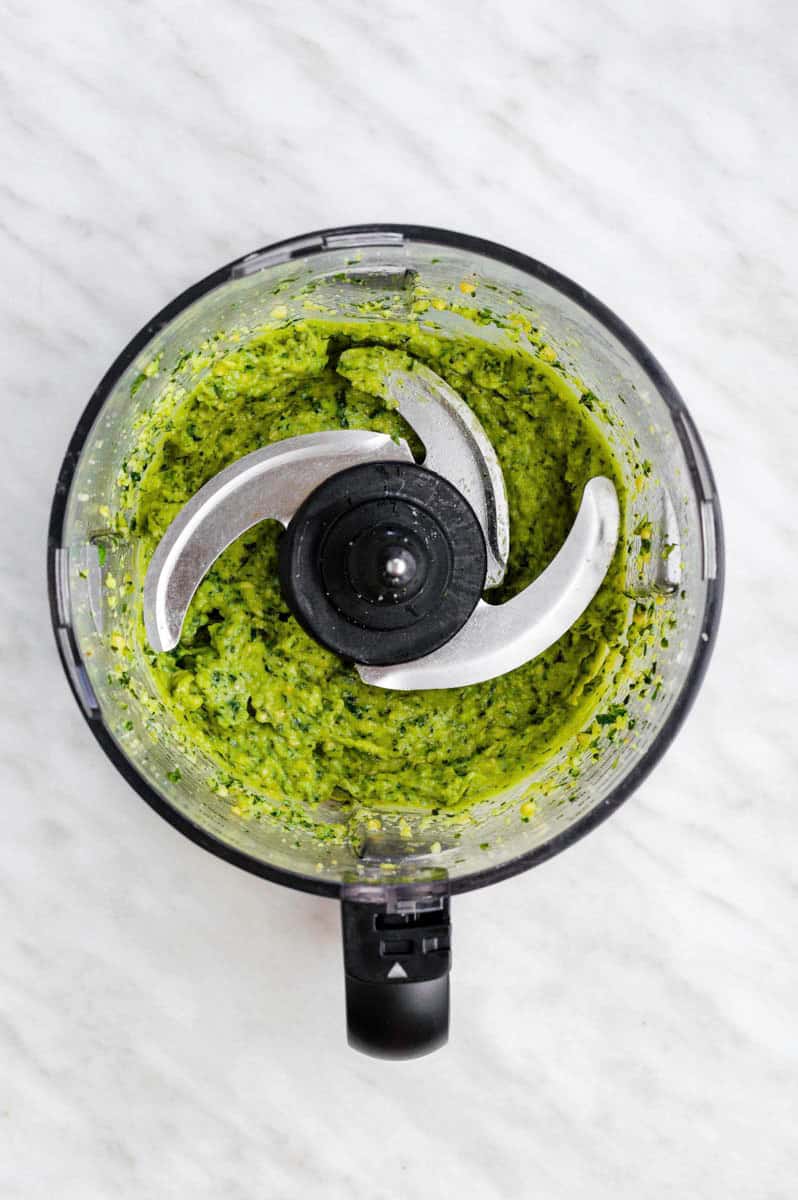 Blended pesto in a food processor.