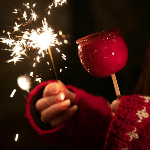 Homemade Toffee Apples with a sparkler.