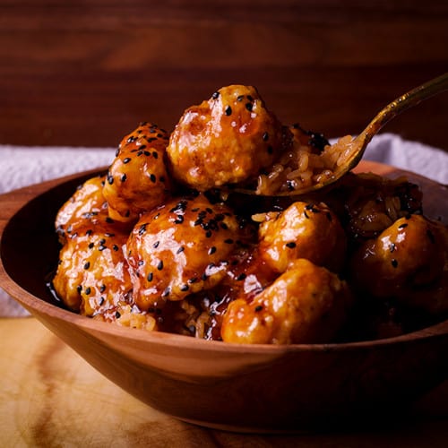 General Tso Cauliflower in a bowl with a spoon.