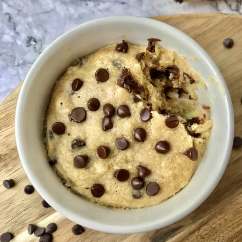 overhead of banana chocolate chip mug cake with some missing.