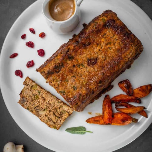 overhead of holiday vegetarian roast on a white plate.