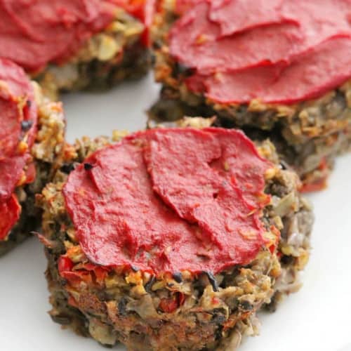 close-up of muffin tin meatloaves on a white plate.