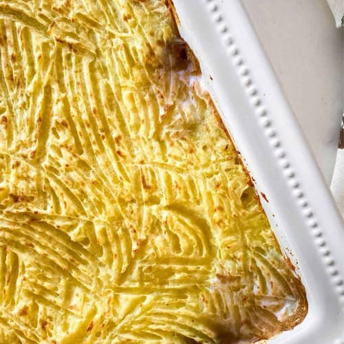 mushroom and lentil pie in a white casserole dish after baking.