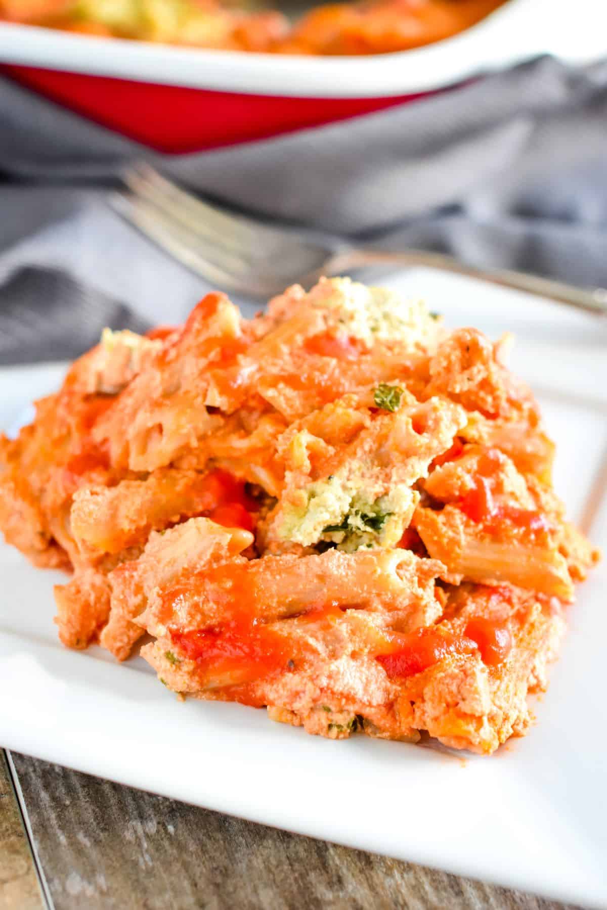 front view close-up of serving of ziti on a white plate.