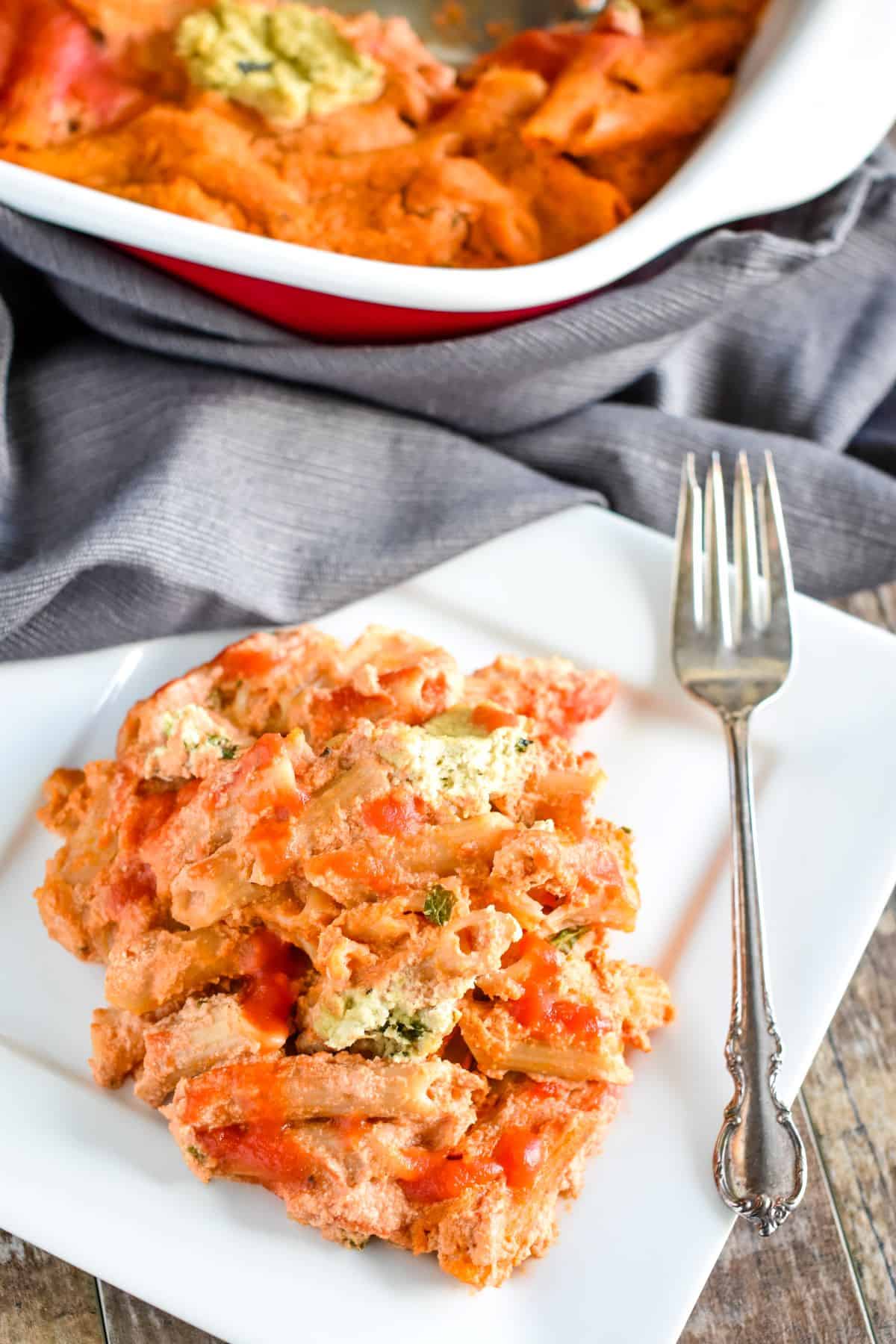 ziti on a white plate with a fork on the plate.