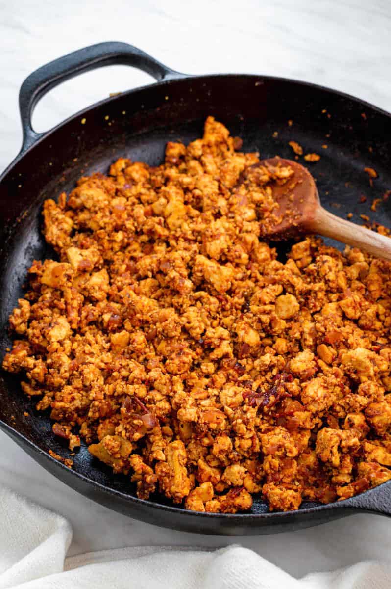 A cast-iron skillet filled with tofu sofritas.