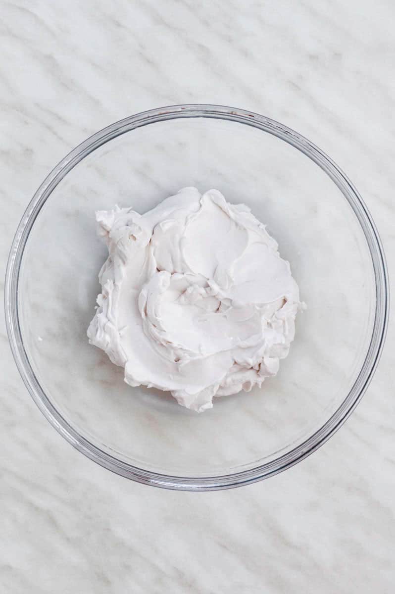 Coconut cream in a clear mixing bowl.