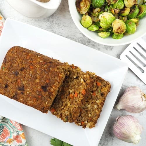 overhead of lentil loaf on a white serving dish.