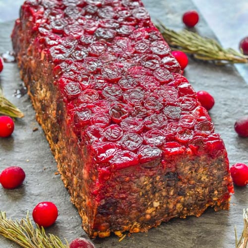 mushroom lentil loaf with cranberries on a slate surface.