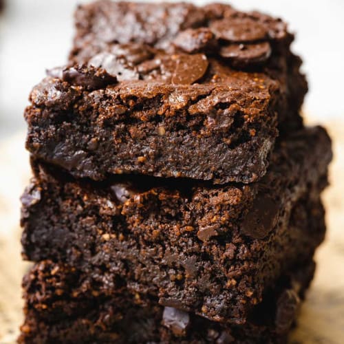 Stack of vegan brownies on newsprint.