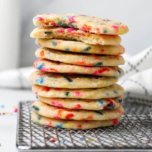 Stack of funfetti cookies on wire rack.