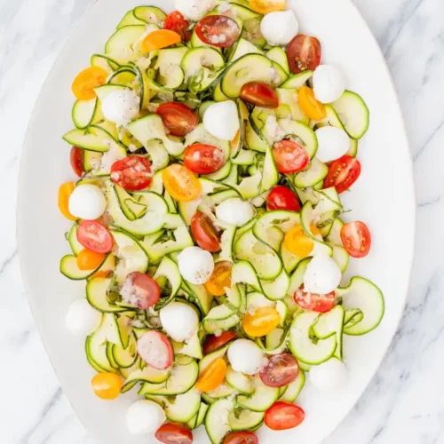 Zucchini Tomato Basil Salad on a white dish.