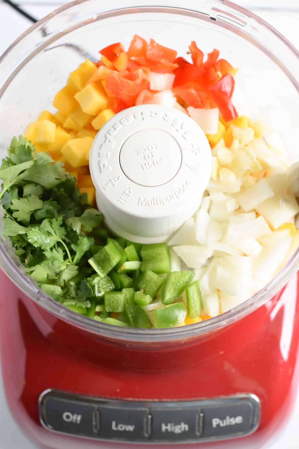 salsa ingredients in food processor before blending.