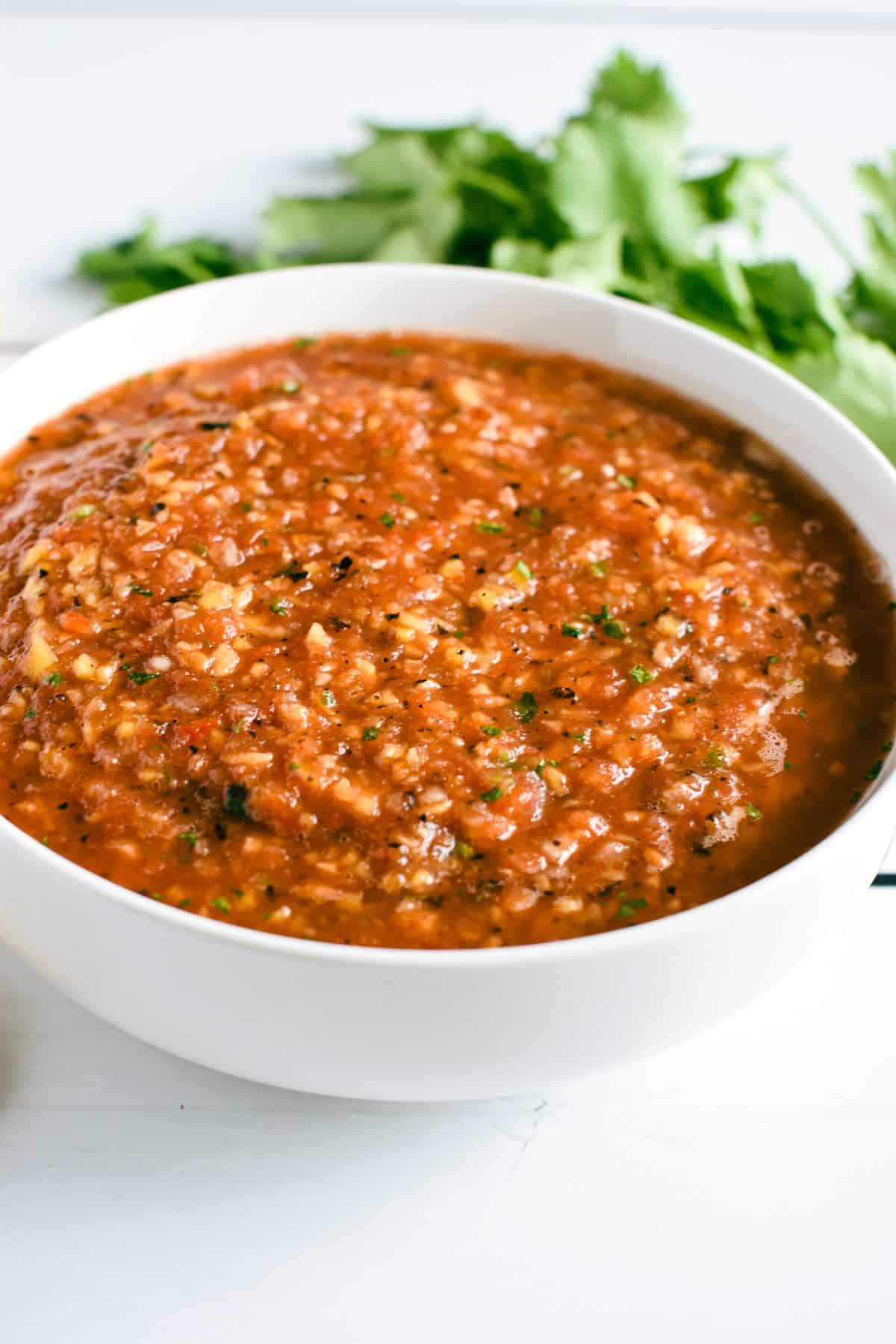 front view of salsa in a white bowl.