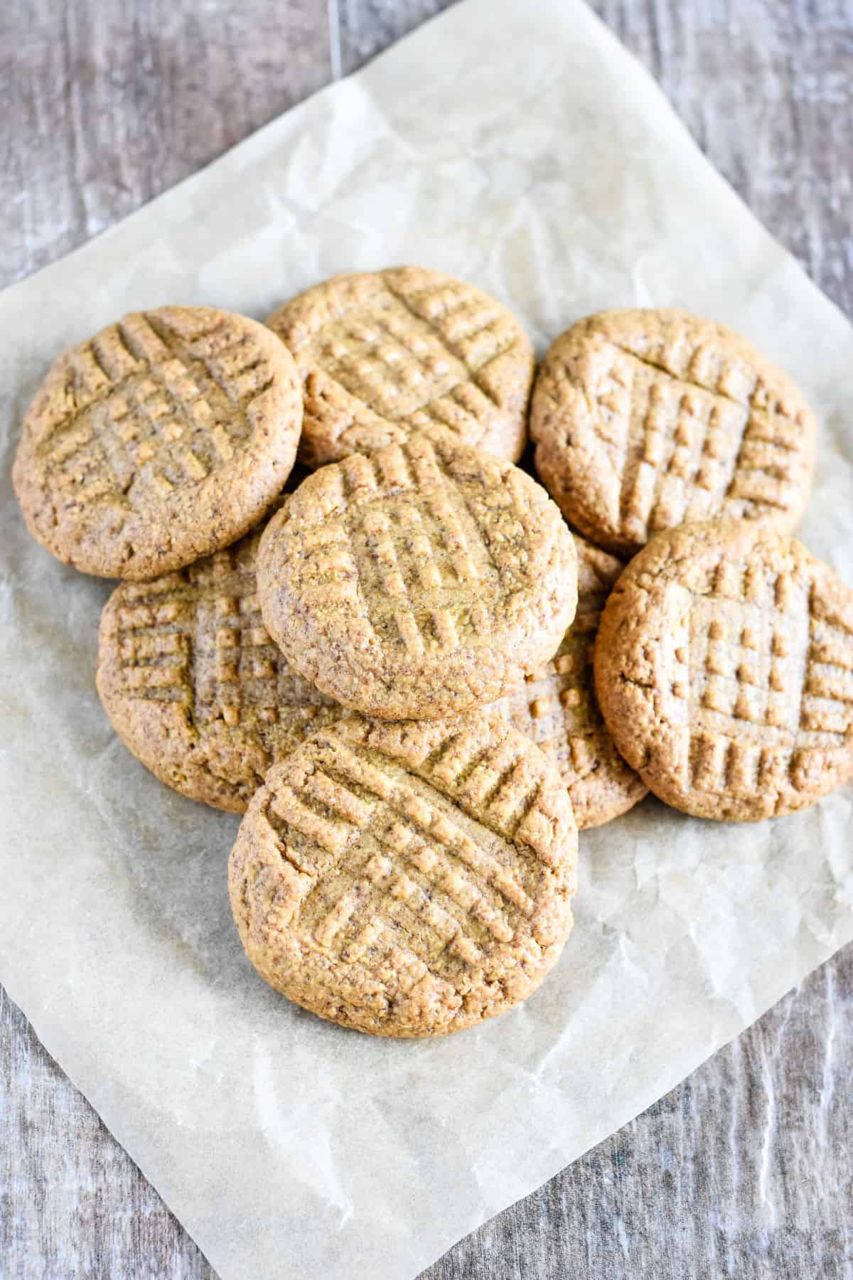 overhead of cookies on top of each other on parchment paper.