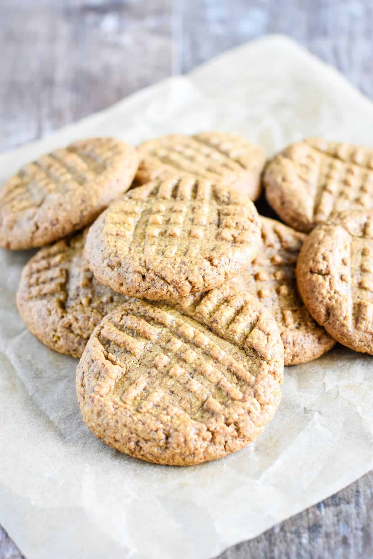 close-up of cookies on top of each other on piece of parchment.