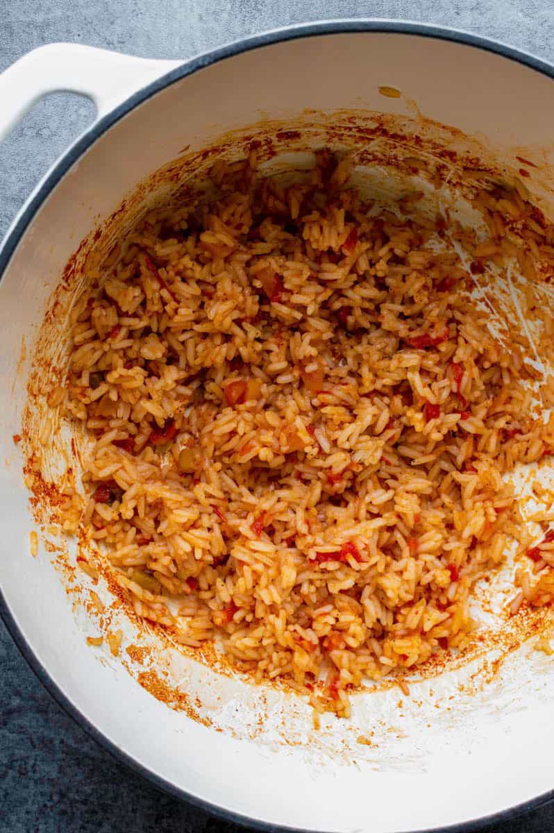 Seasoned rice cooked in a white Dutch oven.